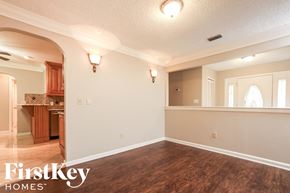 Altamonte Springs house for rent - A room with wooden floors and a FirstKey Homes logo.