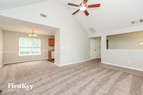 Canton house for rent - A spacious room with a ceiling fan and carpeted floor.
