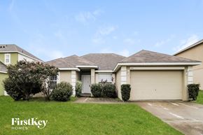 Poinciana house for rent - a home with a lawn and a garage door