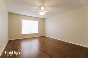 Poinciana house for rent - a bedroom with hardwood flooring and a ceiling fan