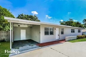 Boynton Beach house for rent - A white house with a red floor mat in front.