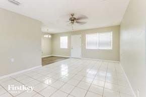 Boynton Beach house for rent - A spacious room with a ceiling fan and tile flooring.