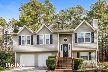 Roswell house for rent - a gray house with black shutters and a white garage door