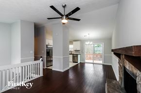 Roswell house for rent - a living room with a staircase and a ceiling fan