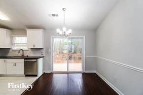 Roswell house for rent - an empty living room with a sliding glass door to a patio