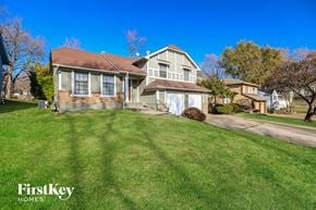 Kansas City house for rent - a home with a green lawn and a blue sky