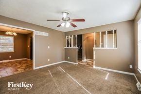 Kansas City house for rent - an empty living room with a ceiling fan and a closet