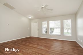 Cape Coral house for rent - the spacious living room with wood flooring and a ceiling fan