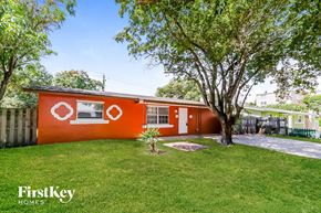 Boynton Beach house for rent - a red house with a yard and a tree