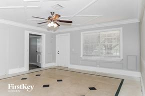 Boynton Beach house for rent - a living room with a ceiling fan and a window
