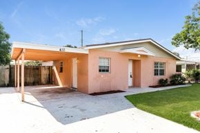 Boynton Beach house for rent - A house with a pink facade and a white roof.