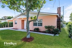 Boynton Beach house for rent - A pink house with a tree in front of it.