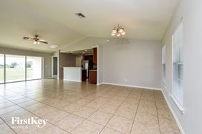 Cape Coral house for rent - a large living room with tile flooring and a kitchen