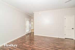 Gardendale house for rent - A room with wooden floors and two doors.