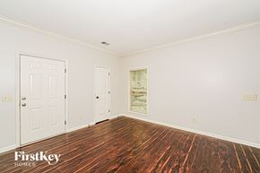 Gardendale house for rent - A room with wooden floors and two white doors.