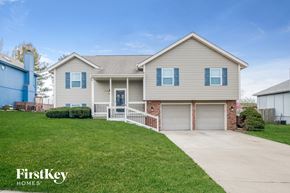 Raymore house for rent - A house with a garage and a driveway is for sale.