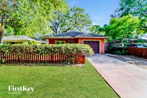 Largo house for rent - a red house with a garden and a sidewalk
