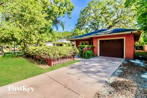 Largo house for rent - a red home with a driveway and a garage door