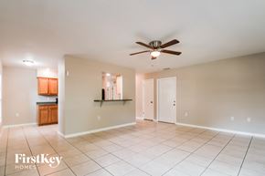 Largo house for rent - an empty living room with a ceiling fan and tiled floor