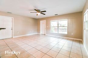 Largo house for rent - an empty living room with a ceiling fan and tiled floors