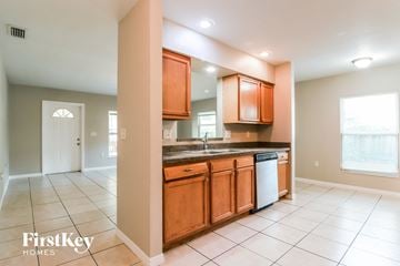 Largo house for rent - a kitchen with wooden cabinets and a sink and a dishwasher