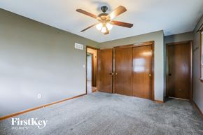 Lee's Summit house for rent - the master bedroom with carpeted flooring and a ceiling fan