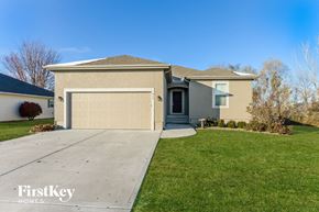 Raymore house for rent - a home with a driveway and a garage door