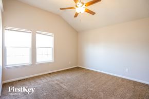 Independence house for rent - a bedroom with two windows and a ceiling fan