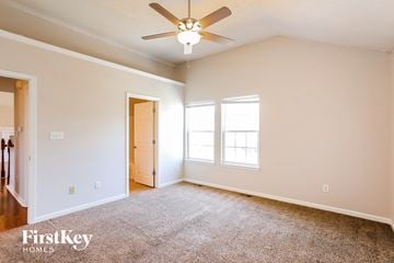 Independence house for rent - a living room with carpet and a ceiling fan
