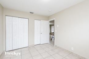 Deerfield Beach house for rent - a bedroom with two closets and a tiled floor