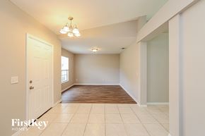Port St. Lucie house for rent - A spacious room with a door on the left and a window on the right.