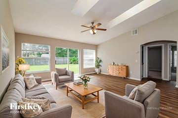 Port St. Lucie house for rent - A living room with a grey couch and a wooden coffee table.