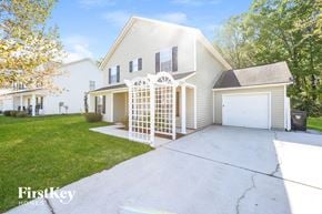 Summerville house for rent - a white house with a driveway and a white garage door