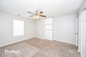Summerville house for rent - a bedroom with carpet and a ceiling fan