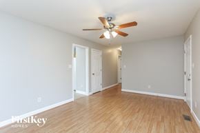 Fuquay Varina house for rent - a living room with wood floors and a ceiling fan