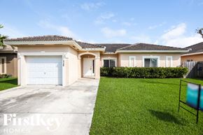 Homestead house for rent - A house with a white garage door is for sale by FirstKey Homes.