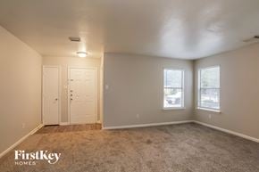 Houston house for rent - A bedroom with a carpeted floor and two doors.