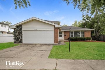 Glenwood house for rent - a home with a white garage door and a lawn