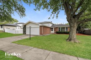 Glenwood house for rent - a white and brick house with a yard and a tree