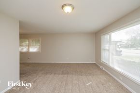 Glenwood house for rent - the spacious living room with large windows and carpeting