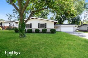 Florissant house for rent - A house with a white garage door is for sale.
