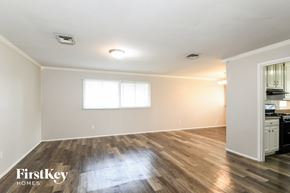 Florissant house for rent - A room with wooden floors and a window is available for rent.