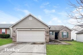 Indianapolis house for rent - a white garage door in front of a brick house
