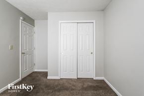 Indianapolis house for rent - a bedroom with two closets and a carpeted floor