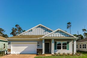 St. Augustine house for rent - A house with a white garage door and a brown roof.