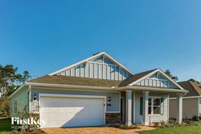 St. Augustine house for rent - A two-story house with a garage is showcased in the image.