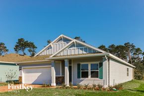 St. Augustine house for rent - A house with a white garage door and a brown roof.