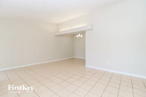 Florissant house for rent - A room with a white wall and a tiled floor.