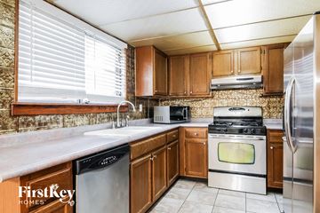 Acworth house for rent - A kitchen with wooden cabinets and stainless steel appliances.