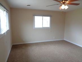 Park Forest house for rent - a living room with a ceiling fan and a window
